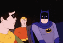 a group of cartoon characters including batman and robin are standing next to each other in a dark room .