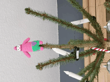 a christmas tree with a crocheted patrick star on top of it