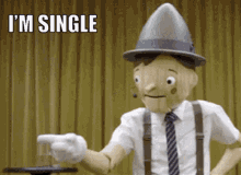 a wooden puppet with a hat and suspenders is pointing at something with the words i 'm single above him