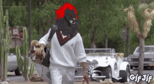 a gif of a man carrying a dog and a stop sign in the background