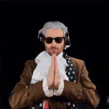 a man in a suit and tie is praying in front of a drawing of a woman