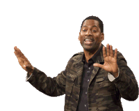 a man wearing a camo jacket is waving his hands