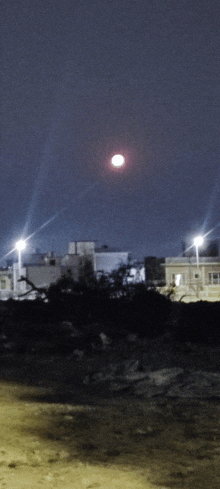 a full moon shines brightly in the night sky