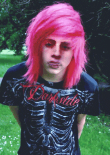 a young man with pink hair is wearing a darkside shirt