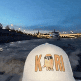 a person wearing a white hat with the word kori on it