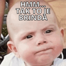 a baby with a serious look on his face and the words hmm tak to je brinda