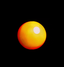 a yellow ball with a white spot in the middle