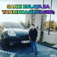 a young man wearing a mask stands in front of a car with the words " sanki zulaya za yatiringa olur gibi "