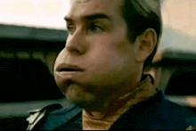 a close up of a man 's face with a huge mouth