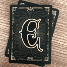 two playing cards with the letter g on the back