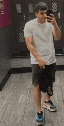 a man taking a selfie in a locker room