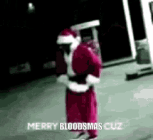 a man dressed as santa claus is holding a gun and says merry bloodsmas cuz .