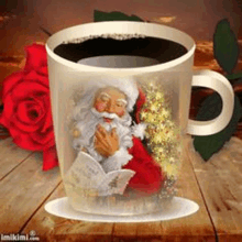 a cup of coffee with santa claus and a christmas tree on it .