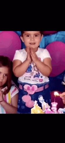 a little girl wearing a shirt that says " girl power "