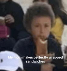 a young boy eating a sandwich with the caption " my mom makes perfectly wrapped sandwiches "