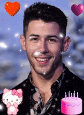 a man with a hello kitty and a pink cake with candles on it