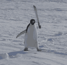 a penguin is holding a large knife in its hand