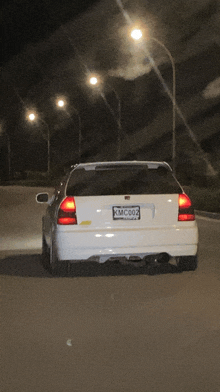 a white car with the license plate kmc002