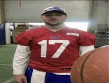 a football player wearing a red jersey with the number 17 on it