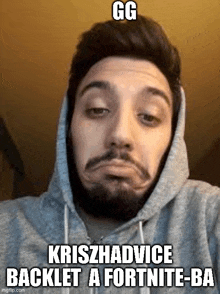 a man with a beard is wearing a hooded sweatshirt and making a funny face .