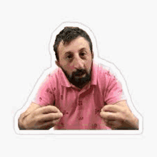 a man with a beard is wearing a pink polo shirt and making a face .