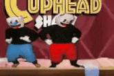 three cartoon characters are standing next to each other on a stage in front of a sign that says cuphead shop .