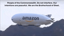 an amazon airship is flying over a hill