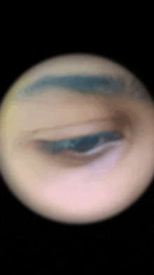 a close up of a person 's eye looking through a telescope lens