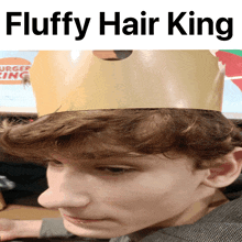 a boy with fluffy hair is wearing a burger king hat