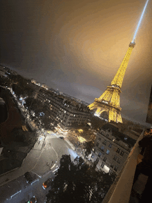 an aerial view of the eiffel tower lit up at night in paris