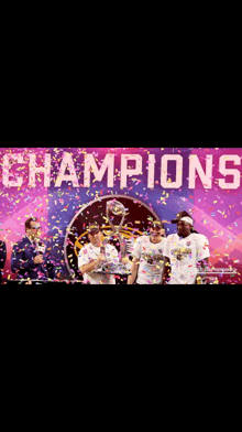 a group of people standing in front of a banner that says champions