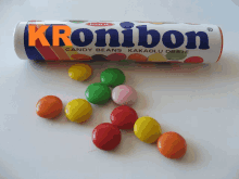 a tube of kronibon candy beans sits next to some candy beans