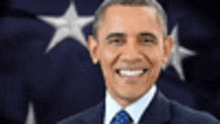 barack obama is smiling in front of the american flag