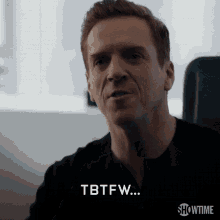a man is sitting in a chair and says tbtfw