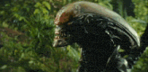 a close up of a statue of an alien in a forest .
