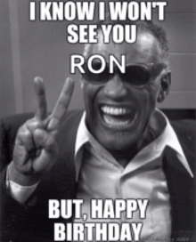 a black and white photo of a man giving the peace sign