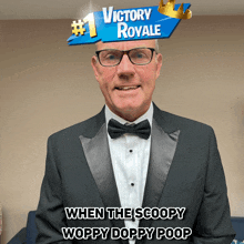 a man in a tuxedo is wearing a victory royale sticker on his head