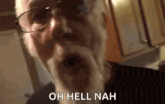 a man with glasses and a beard is screaming .