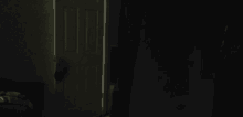 a door in a dark room with a light coming out of it