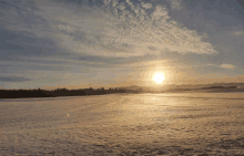 the sun shines brightly over a snowy field