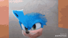 a person is drawing sonic the hedgehog with a pencil on a piece of paper .