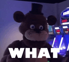 a teddy bear with a top hat is standing in front of a slot machine with the word what written on it .