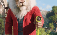a lion dressed as santa claus is holding a hose