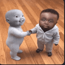 two baby dolls shaking hands on a wood floor