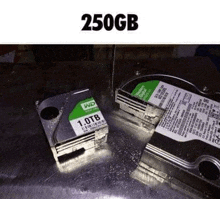 two hard drives are sitting on top of a metal surface .