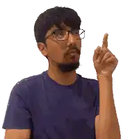 a man wearing glasses and a blue shirt is pointing upwards