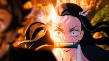 a close up of a person 's face with a fireball coming out of her mouth .