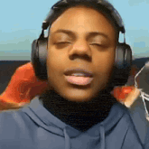 a close up of a person wearing headphones with their eyes closed