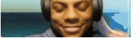 a man wearing headphones is smiling with his eyes closed