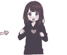 a girl in a black hoodie with a heart on her chest is standing next to an arrow pointing at her .